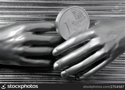 silver euro coins in futuristic robot gray metallic hands bank metaphor