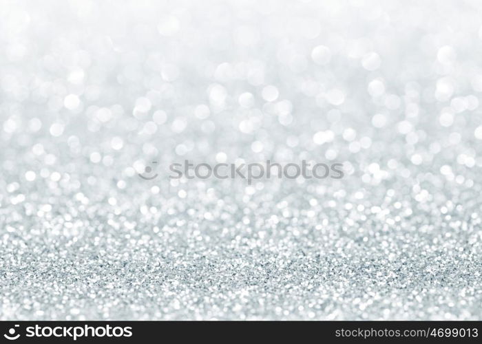 Silver festive glitter background with defocused lights