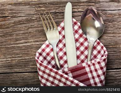 silver fork, knife and spoon as utensils on wooden table