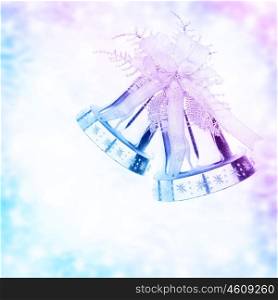 Silver jingle bell border, Christmas tree ornament and holiday decoration isolated on blue and purple blurry background