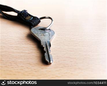 Silver key isolated on wood floor selective focus - busines, success and allow to access concept