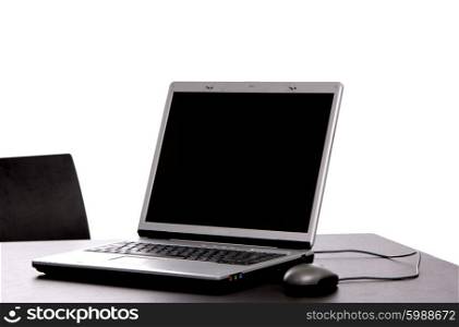 silver laptop with mouse on a office desk