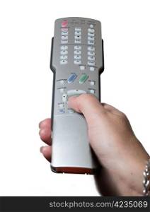 Silver modern TV remote control being pressed by thumb isolated against white background