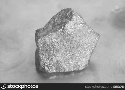 Silver nugget on a gray background