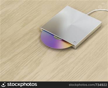 Silver optical disc drive on wood background
