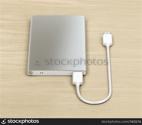 Silver power bank with usb-c cable on wood table