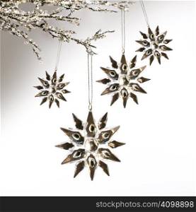 Silver snowflakes hanging against pale grey background