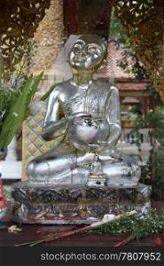 Silver statue of buddhist monk on shrine in wat, Chiang Mai, Thailand