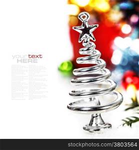 Silver stylized Christmas tree with decorations over white
