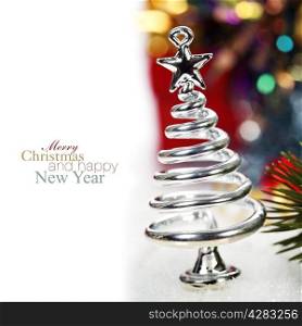 Silver stylized Christmas tree with decorations over white