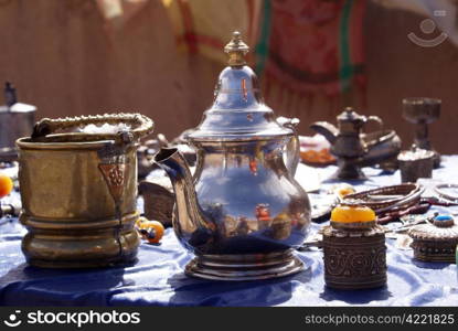 Silver teapot and souvenirs on the table in Morocco