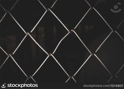 Silver wire mesh weave, black background