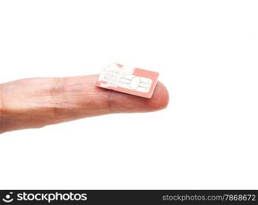 SIM card on finger isolated on white