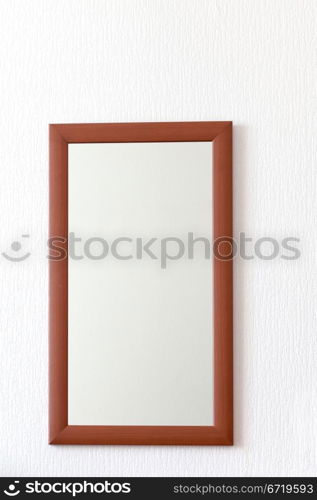 simple wall mirror in wooden brown frame