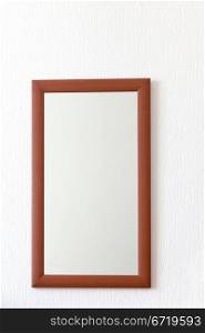 simple wall mirror in wooden brown frame