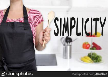 simplicity cook holding wooden spoon concept background. simplicity cook holding wooden spoon concept background.