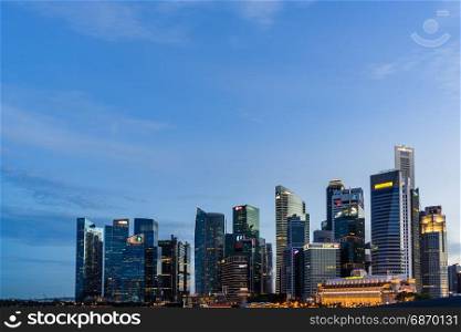 Singapore - August 1, 2017: Singapore skyline dusk and illuminated financial district night view, Downtown Urban cityscape of Singapore. Modern skyscrapers of business district Marina Bay
