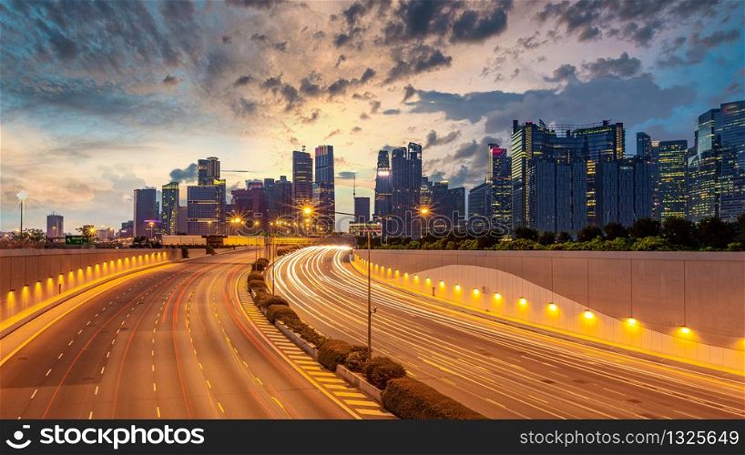 Singapore city highway traffic with movement of car light with Singapore cityscape skyline and skyscraper background.