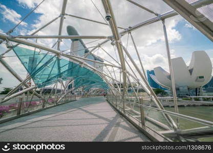 Singapore City, SINGAPORE - FEB 10, 2017: Helix bridge with Marina Bay Sands in background. Tourism in Singapore is major industry and contributor to Singapore economy.