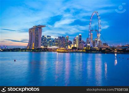 Singapore city skyline at twilight with view of Marina Bay.