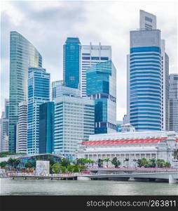Singapore city skyline with embankment by downtown core in overcast weather