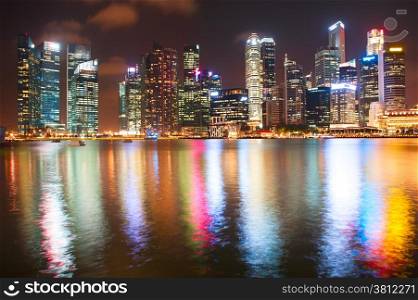 Singapore Downtown Core reflected in the river at night
