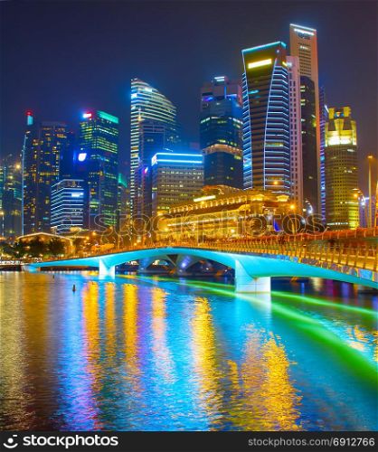 Singapore Downtown reflected in a river at night