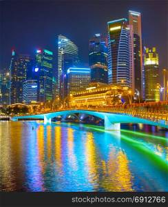 Singapore Downtown reflected in a river at night