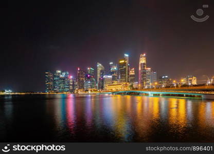 Singapore Downtown skyline at night with reflection. Financial district and business centers in technology smart urban city in Asia. Skyscraper and high-rise buildings.