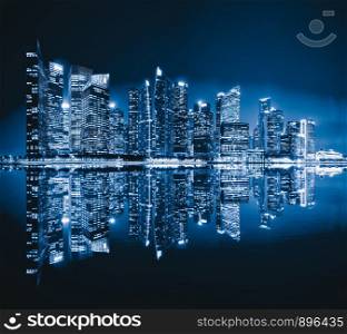 Singapore Downtown skyline at night with reflection. Financial district and business centers in technology smart urban city in Asia. Skyscraper and high-rise buildings.