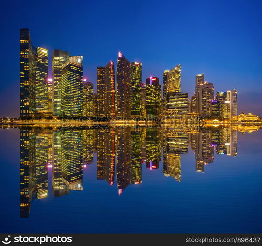 Singapore Downtown skyline at night with reflection. Financial district and business centers in technology smart urban city in Asia. Skyscraper and high-rise buildings.