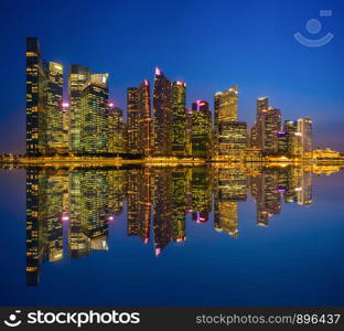 Singapore Downtown skyline at night with reflection. Financial district and business centers in technology smart urban city in Asia. Skyscraper and high-rise buildings.