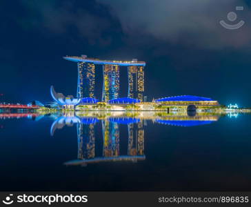 Singapore Downtown skyline at night with reflection. Financial district and business centers in technology smart urban city in Asia. Skyscraper and high-rise buildings.