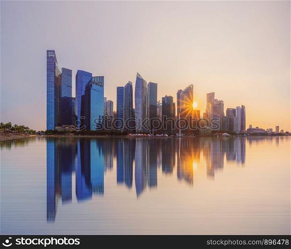Singapore Downtown skyline at sunset with reflection. Financial district and business centers in technology smart urban city in Asia. Skyscraper and high-rise buildings.