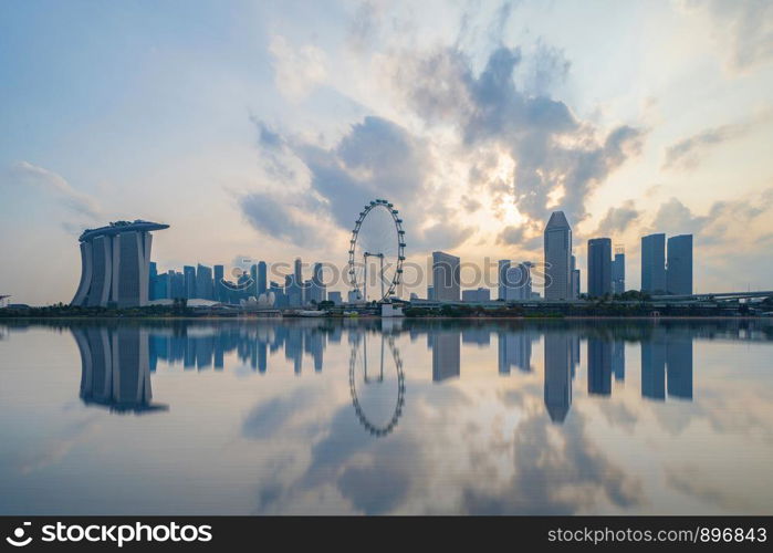 Singapore Downtown skyline at sunset with reflection. Financial district and business centers in technology smart urban city in Asia. Skyscraper and high-rise buildings.
