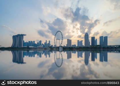 Singapore Downtown skyline at sunset with reflection. Financial district and business centers in technology smart urban city in Asia. Skyscraper and high-rise buildings.