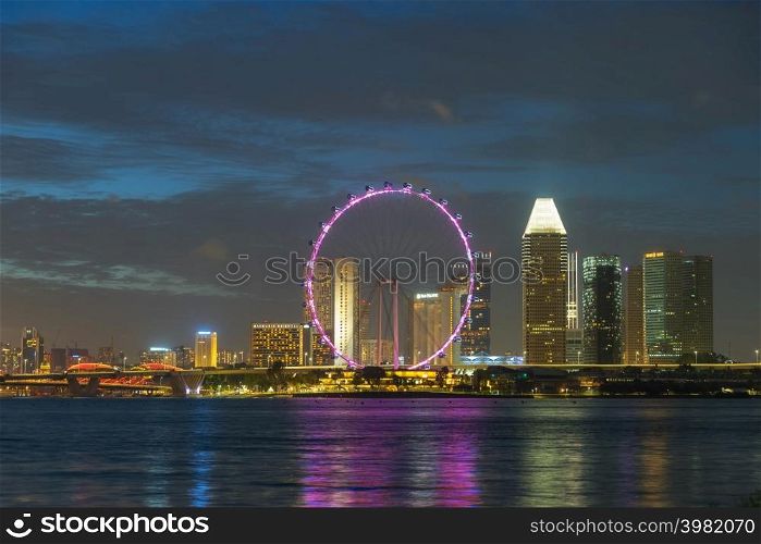 SINGAPORE - FEBRUARY 2: Singapore Ferris Wheel and business district and city, Marina Bay is bay located in the Central Area of Singapore on February 2, 2020 in Singapore.. Travel Holiday in Singapore.