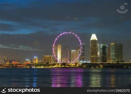 SINGAPORE - FEBRUARY 2: Singapore Ferris Wheel and business district and city, Marina Bay is bay located in the Central Area of Singapore on February 2, 2020 in Singapore.. Travel Holiday in Singapore.
