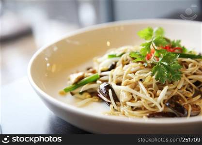 Singapore fried noodle on wood background