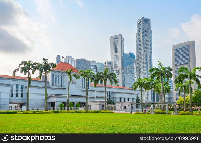 Singapore government building by green lawn, modern cityscape in background