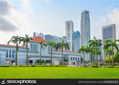 Singapore government building by green lawn, modern cityscape in background