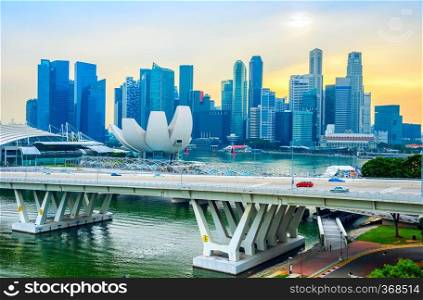 Singapore Marina Bay skyline with Artsience museum and modern transportation bridge at sunset
