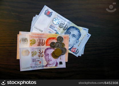 Singapore money on wooden table