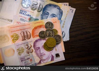 Singapore money on wooden table