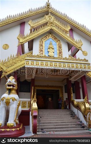 SINGAPORE - OCTOBER 27, 2014: The largest pure white marble statue of the Buddha outside of Myanmar temple on October 27 2014 in Singapore. Maha Sasana Ramsi Burmese Buddhist Temple is a religious landmark in Singapore