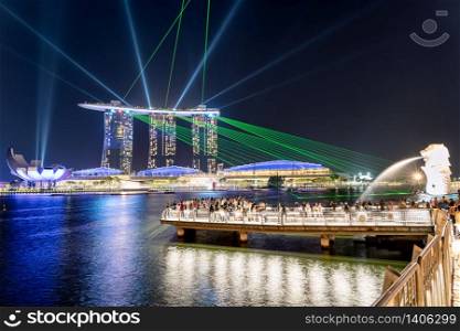 Singapore, Singapore - Aug 3, 2019 : Singapore skyline of marina bay Beautiful laser show at Marina Bay Sands Hotel in night time, popular for tourist and landmark center with cost of US$ 4.7 billion.