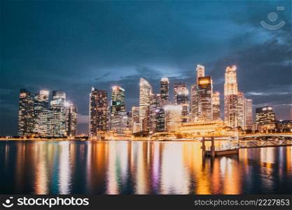 SINGAPORE, SINGAPORE - MARCH 2019  Skyline of Singapore Marina Bay at night with Marina Bay sands, Art Science museum , skyscrapers and tourist boats