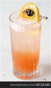 Singapore Sling cocktail garnished with orange wheel and cherry