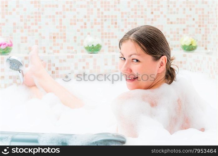 single girl sitting in the jacuzzi with foam