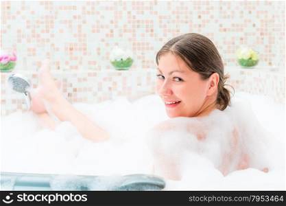 single girl sitting in the jacuzzi with foam